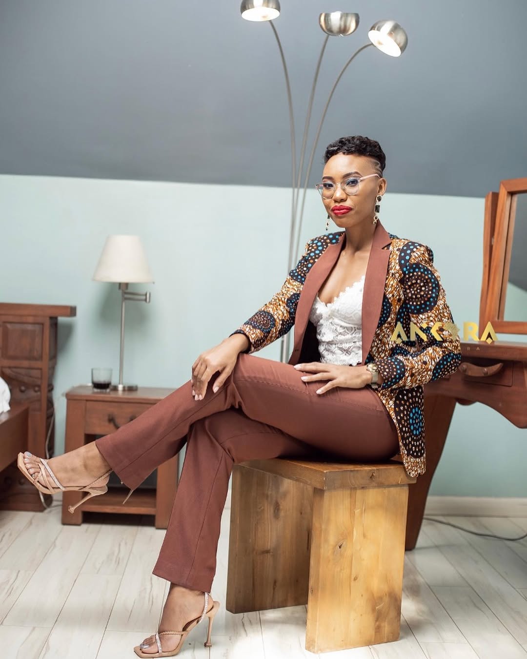 Model wearing a gold and brown tailored Ankara gown by Mwara Urembo